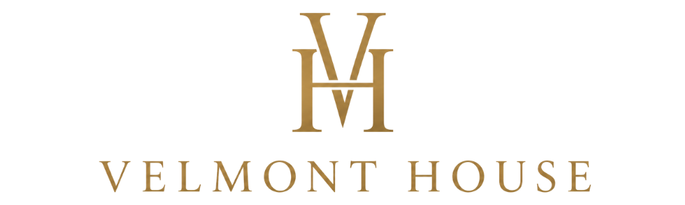 Gold velvet logo with the letters 'VM' above the text 'VELMONT HOUSE' on a solid white background.